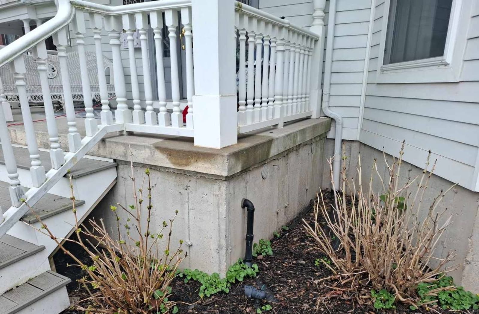 Light gray concrete porch foundation before parging