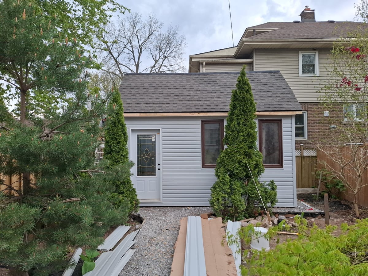 Finished backyard shed build with exterior siding and trim