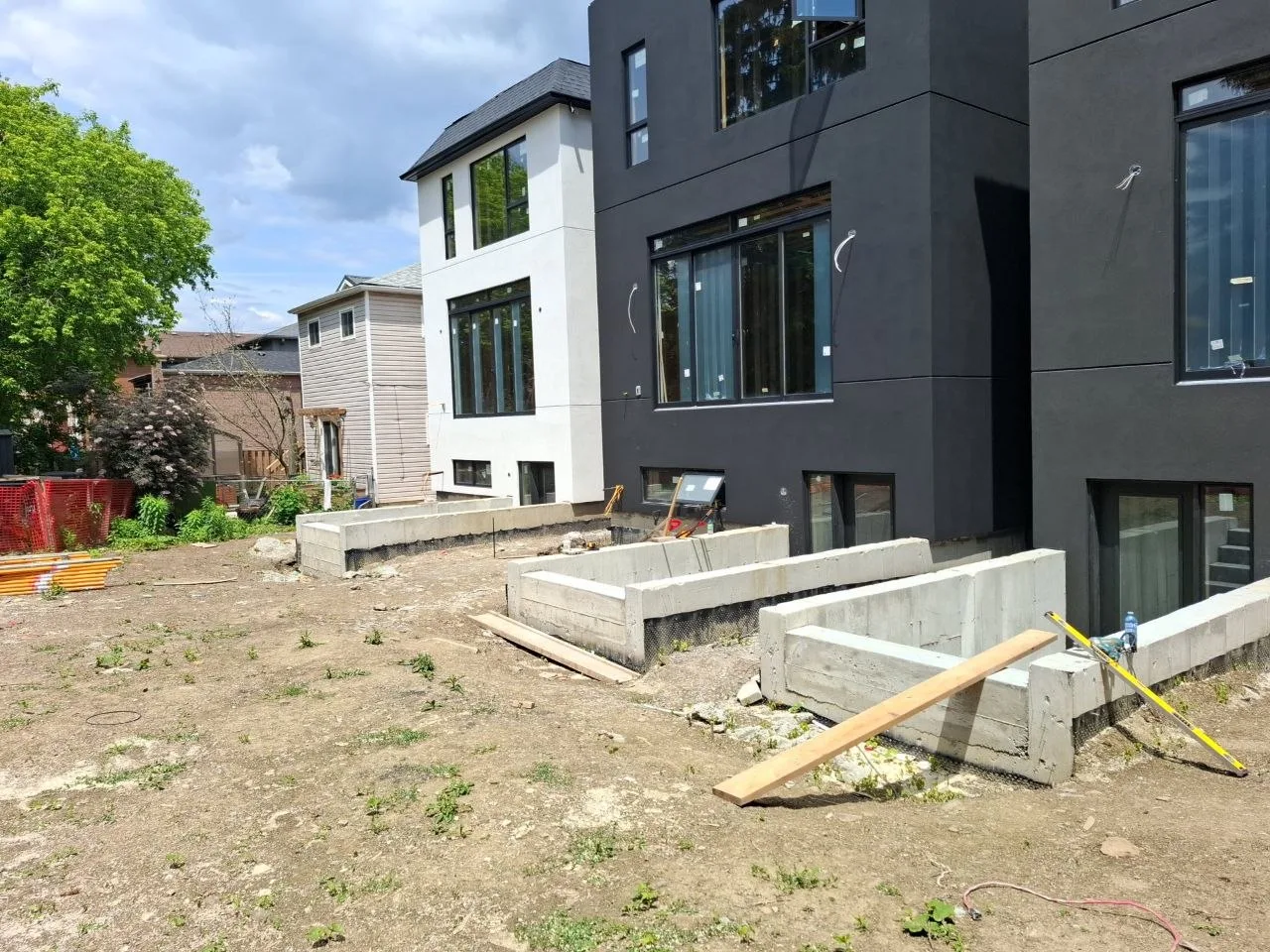 Modern Toronto townhome deck build with natural wood decking and railing — rear yard before grade