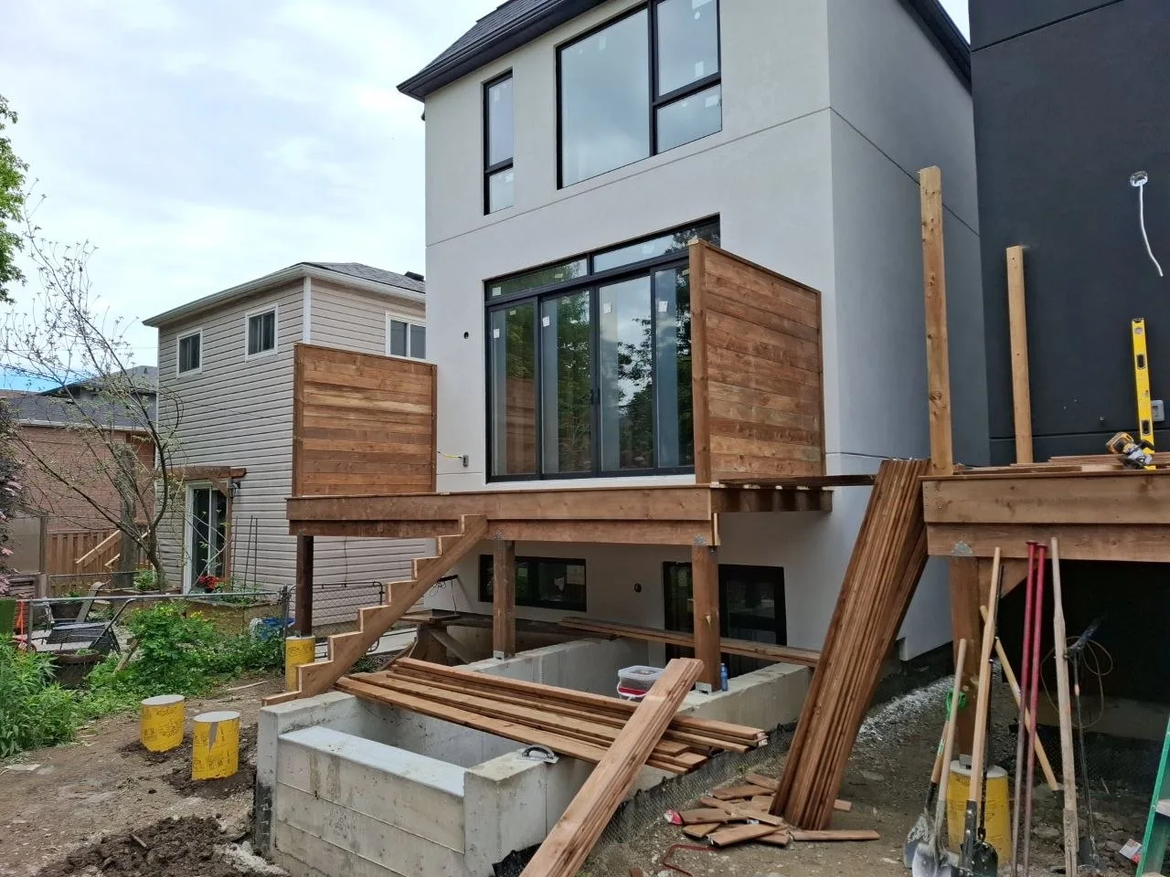 Modern Toronto townhome deck build with natural wood decking and railing — finished decks three units